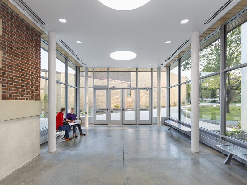 Interior of new vestibule on older school with two boys talking