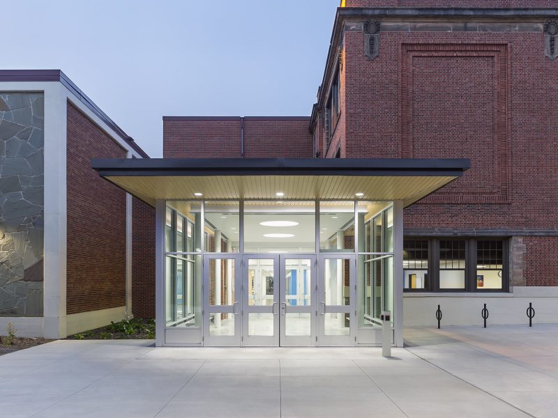 Looking into new vestibule addition to older school at dusk